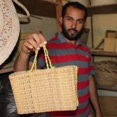 A craftsman making beautiful baskets from wetland plants. Photo: H. Naoufel